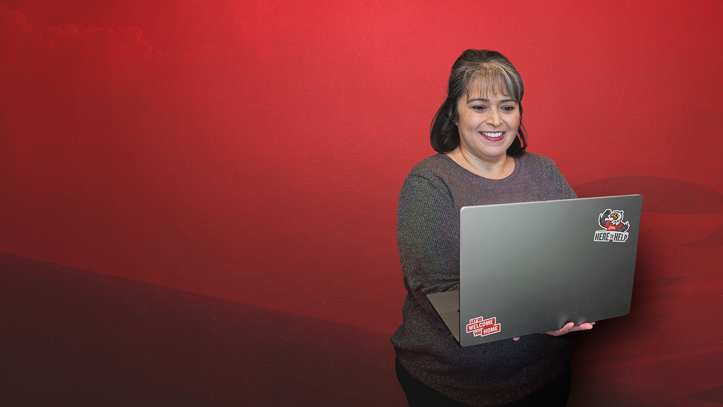 Woman holding laptop.